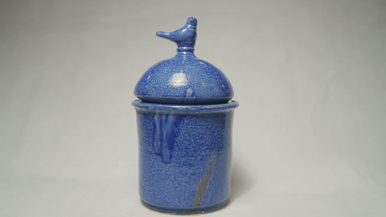 Blue handmade clay tableware on a white background