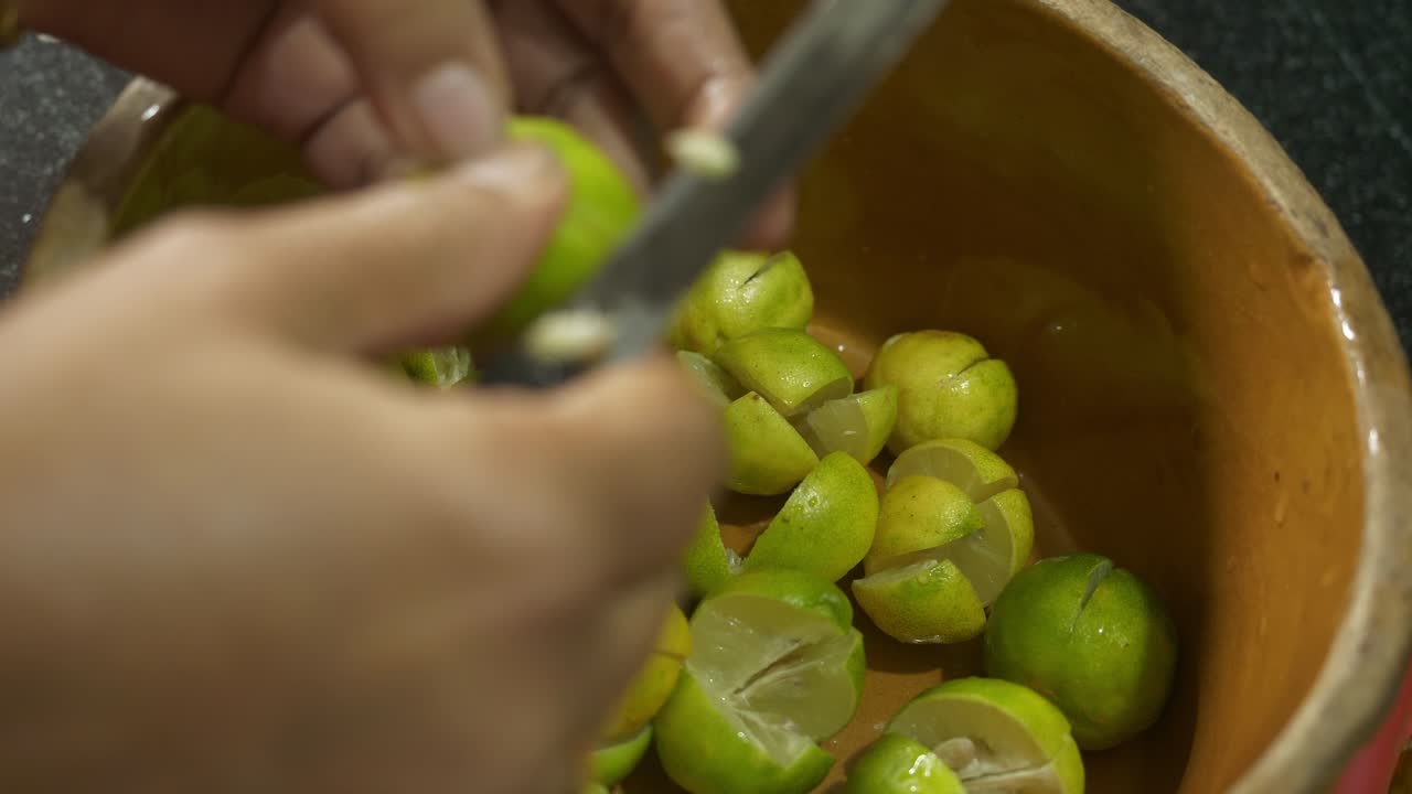 Indian housewife cutting lemons to make traditional pickle