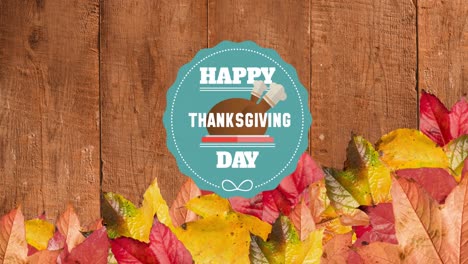 Animation-of-happy-thanksgiving-day-text-over-wooden-background-with-autumn-leaves