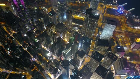 noche iluminada ciudad de hong kong centro de la bahía aérea abajo panorama 4k china