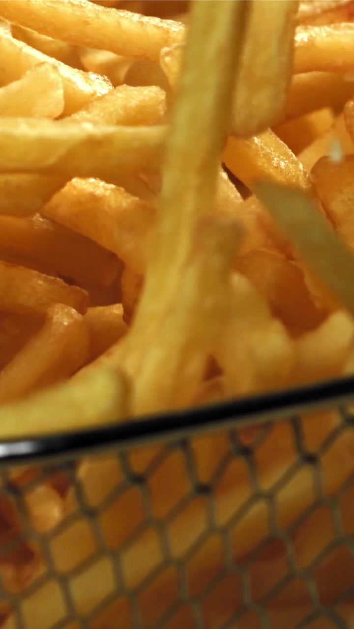Sprinkling Salt on Crispy Golden French Fries