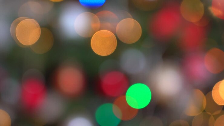 Shimmering abstract colored circles defocused christmas lights background. Blurred fairy lights. Out of focus holiday background christmas tree. Light bokeh from Xmas tree. Xmas and New Year theme. 4k video