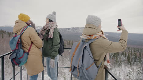 friends hiking in snowy mountains