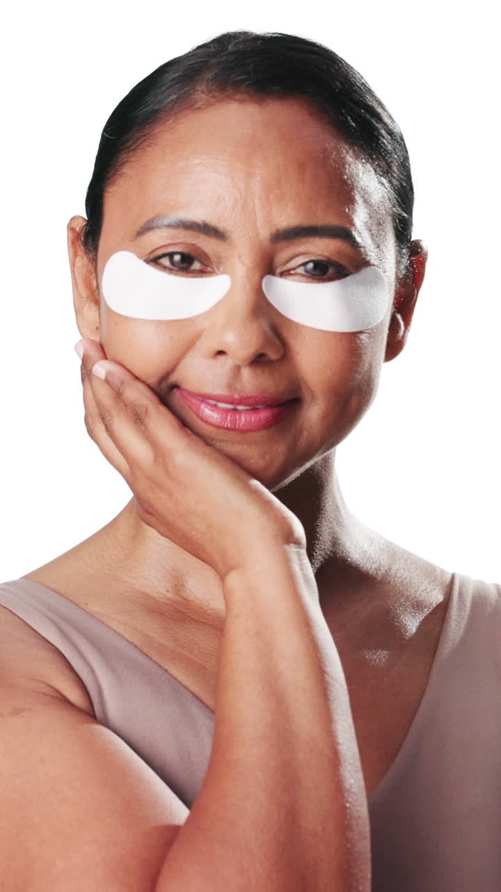 Mature Woman Applying Under Eye Patches for Skincare