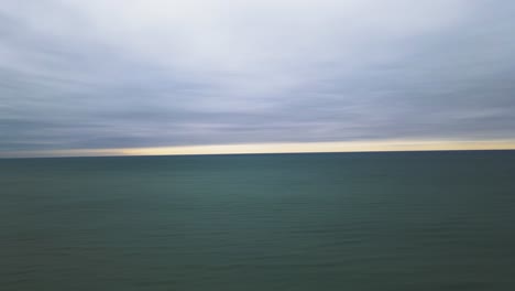 horizon line covered in clouds on the coast of a great lake