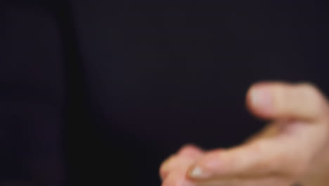 person holding a christmas snow globe with a penguin