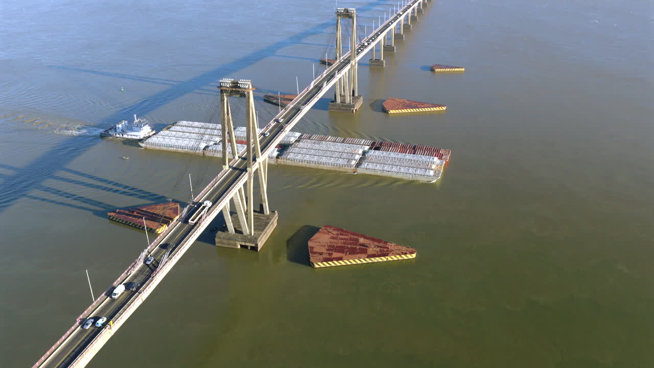 Cargo ship passing under the General Belgrano Bridge over the Paraná River in Corrientes, Argentina