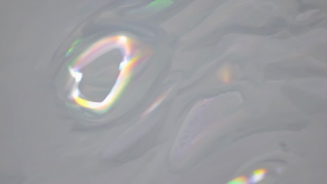 Abstract close-up video still of swirling gray and white marble texture, capturing fluid motion