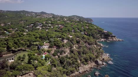 green forest of lloret de mar with the luxury homes on the hills