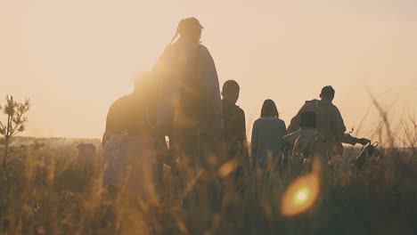 group walks along meadow in autumn morning slow motion