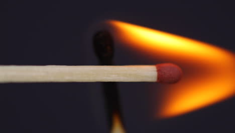 Ignition-matches-close-up-macro-shot-from-side-view-captured-in-front-of-black-background-in-slow-motion-at-120-fps