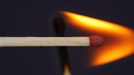 ignition matches close up macro shot from side view captured in front of black background in slow motion at 120 fps