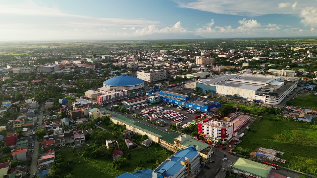 Picturesque aerial flyover of developed Naga City with buildings and bus terminal at Camarines Sur, Philippines during daytime