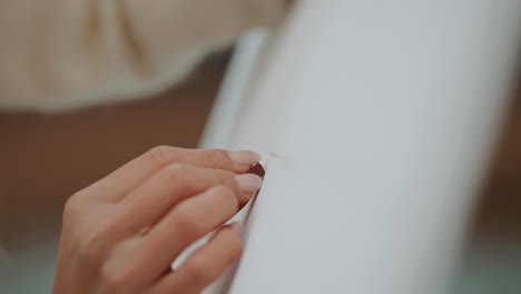 person sewing a seam on fabric