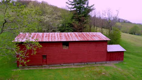 red barn on farm near boone nc, north carolina and blowing rock nc in spring