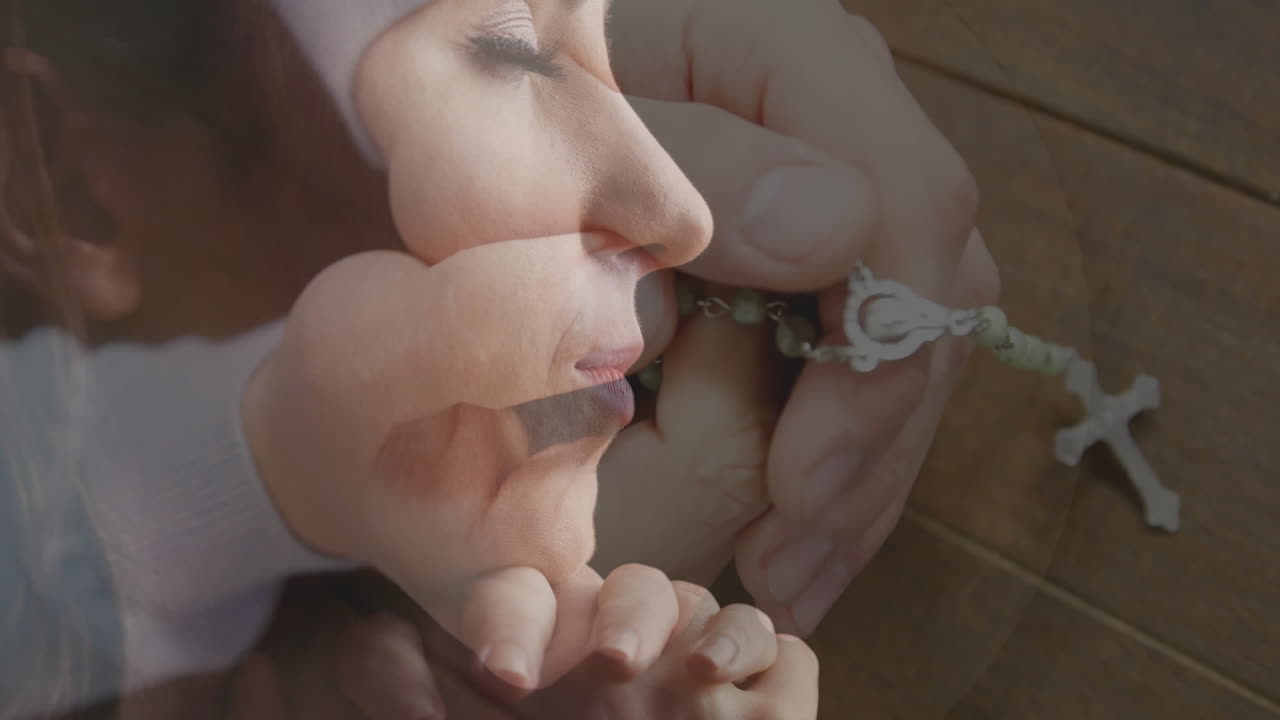 Holding rosary beads, hands in prayerful contemplation over serene face