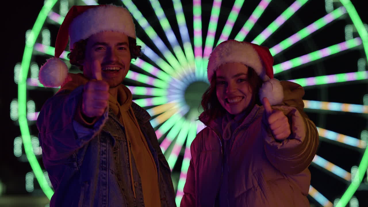 Happy couple showing thumbs up outdoor