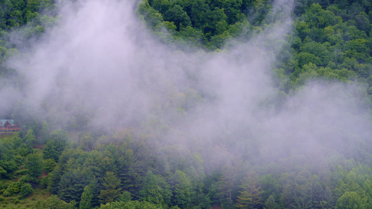 Drone flyover drifting across a peaceful, fog-hushed valley