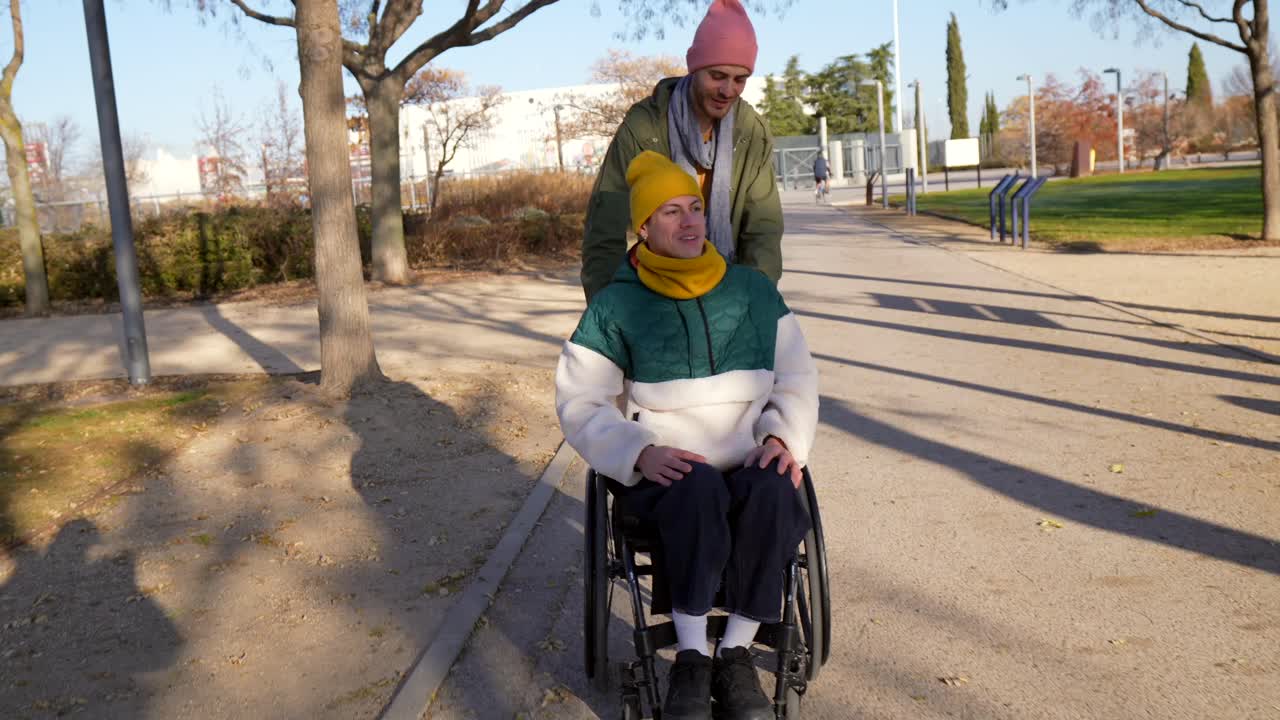 Couple in park, woman in wheelchair