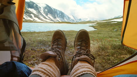 relaxing in a tent with a mountain lake view