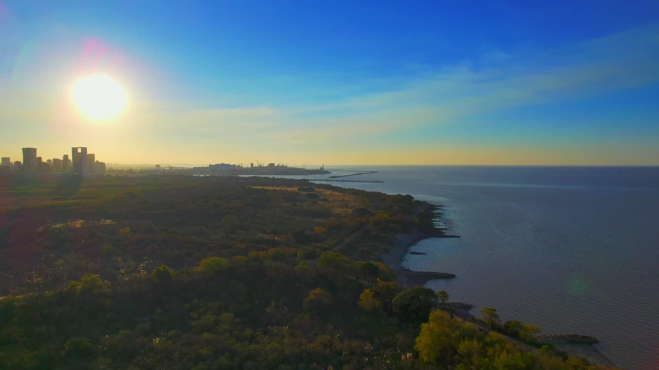 Sunset with the view of the Ecological Reserve of Buenos Aires (Reserva Ecologica) and the city. This ecological reserve is an enormous green spot between the city and the river.