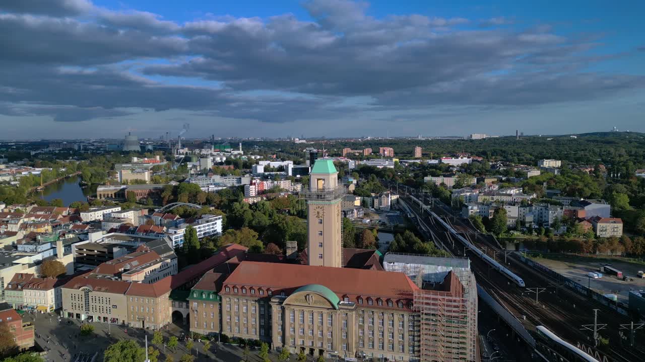 Aerial view showing Rathaus Spandau building, subway station, and public transportation in Berlin. Beautiful aerial view flight fly push forward drone
