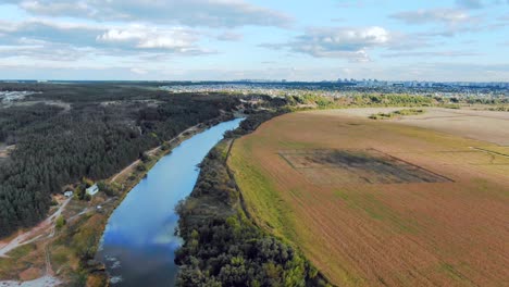 aerial view of river, fields, and cityscape