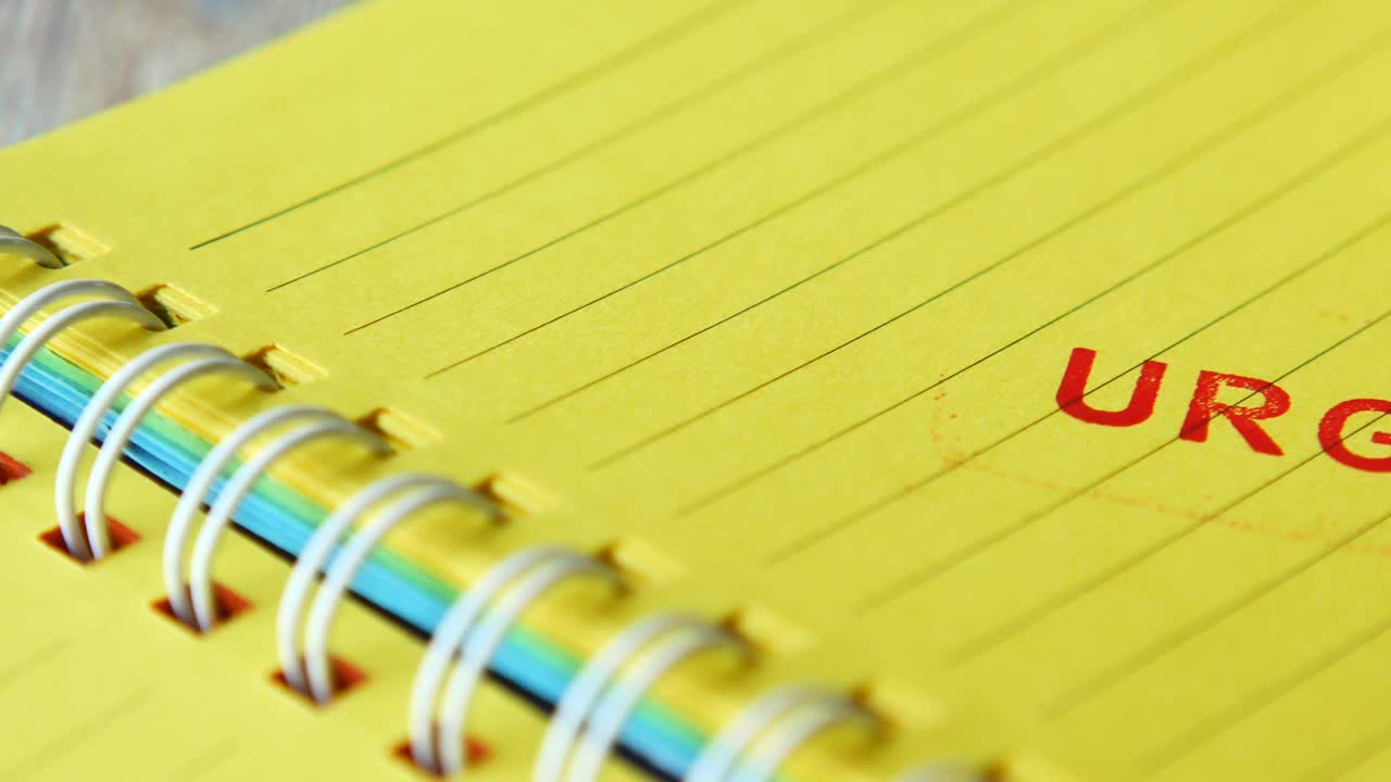 Urgent Stamp on Yellow Notepad