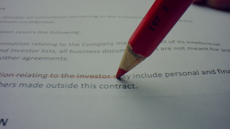Pencil drawing line on paper. Person editing printed document with wooden pencil