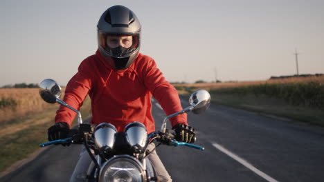 A-young-man-on-a-motorbike-rides-along-the-picturesque-fields-2