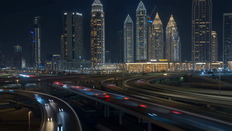 night view of a modern city with illuminated skyscrapers and busy highways