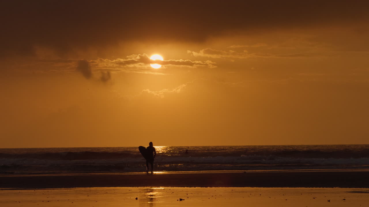 Surfer at Sunset on the Beach