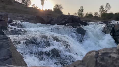 Water-Flowing-In-The-Waterfalls-At-Sunset