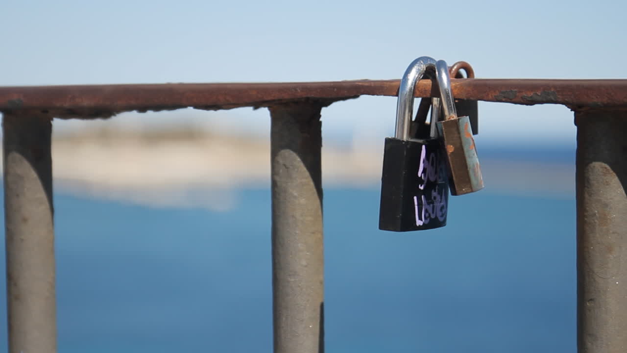 Love locks on a railing overlooking the ocean