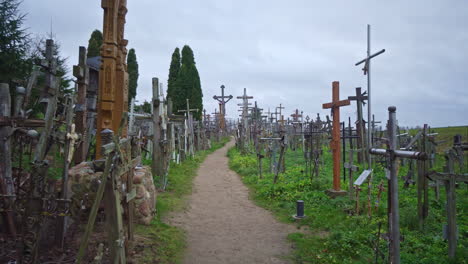 Handheld-POV-shot-following-a-narrow-path-with-thousands-of-catholic-crosses