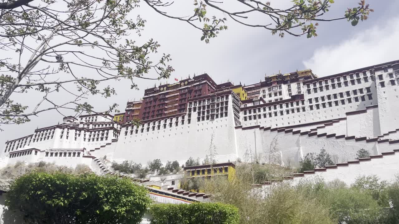 Establishing wide static of Potala Palace and its surroundings on bright day with visible courtyards