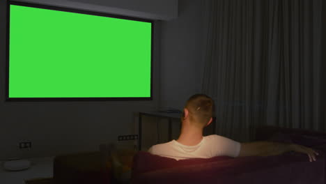 man watching a movie at home