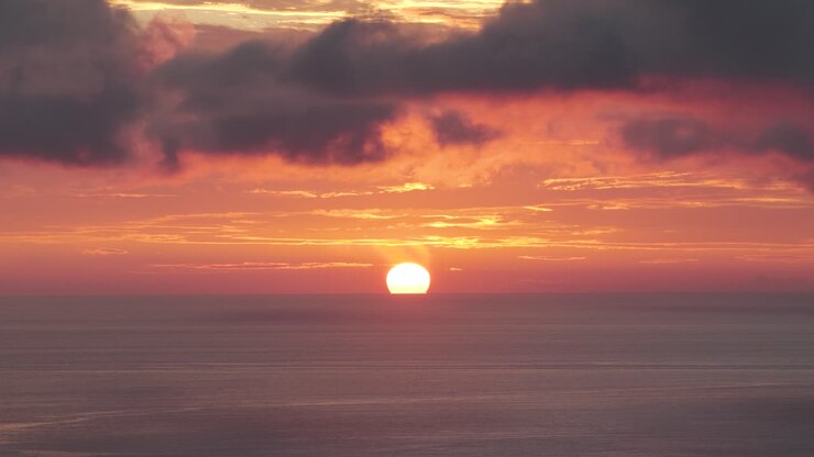 Vibrant Sunset Over Calm Ocean with Colorful Sky