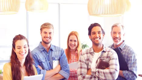 Business-colleagues-standing-with-arms-crossed-in-office