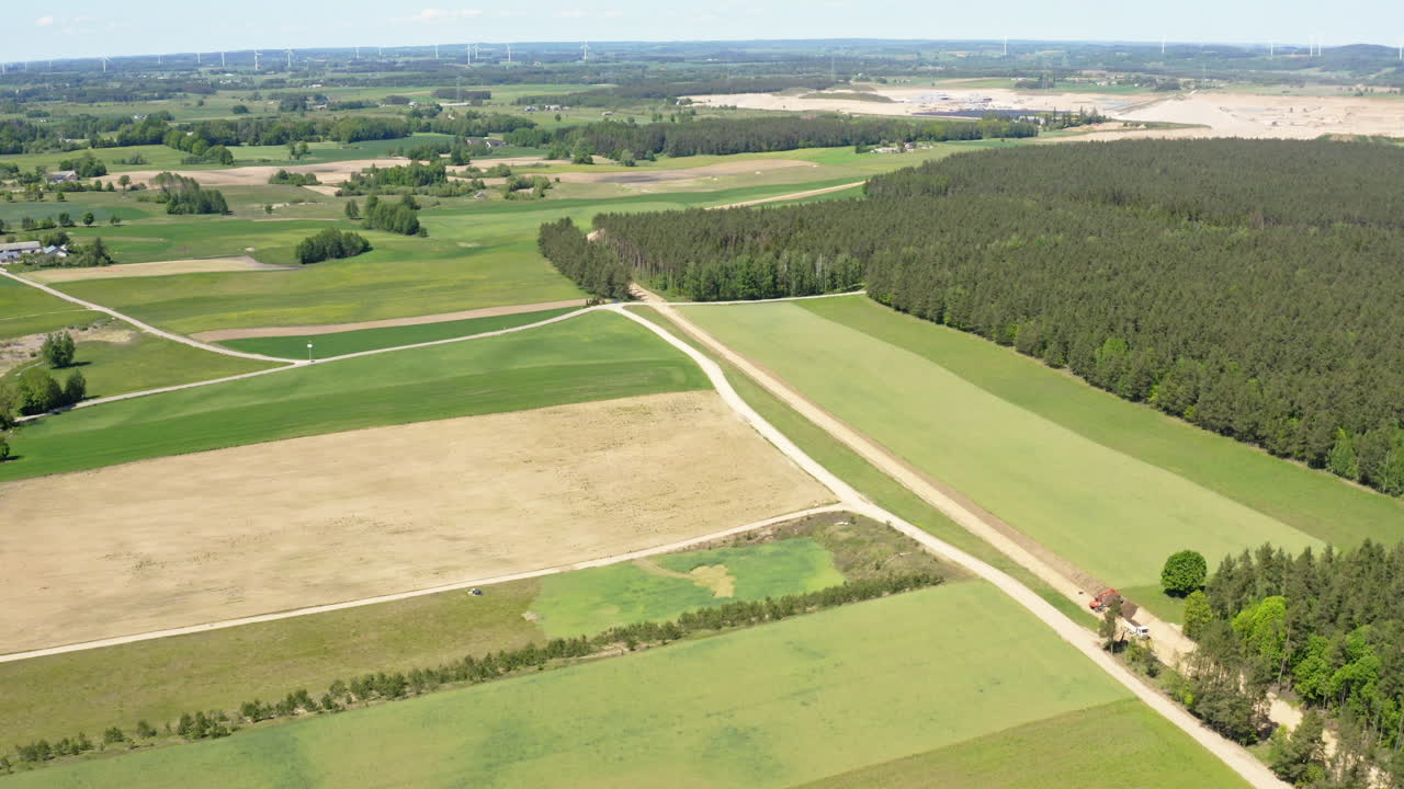 Aerial View Of Dense Forest And Green Fields In The Countryside.