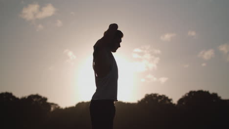 Man-Stretchs-In-Park-Before-He-Works-Out