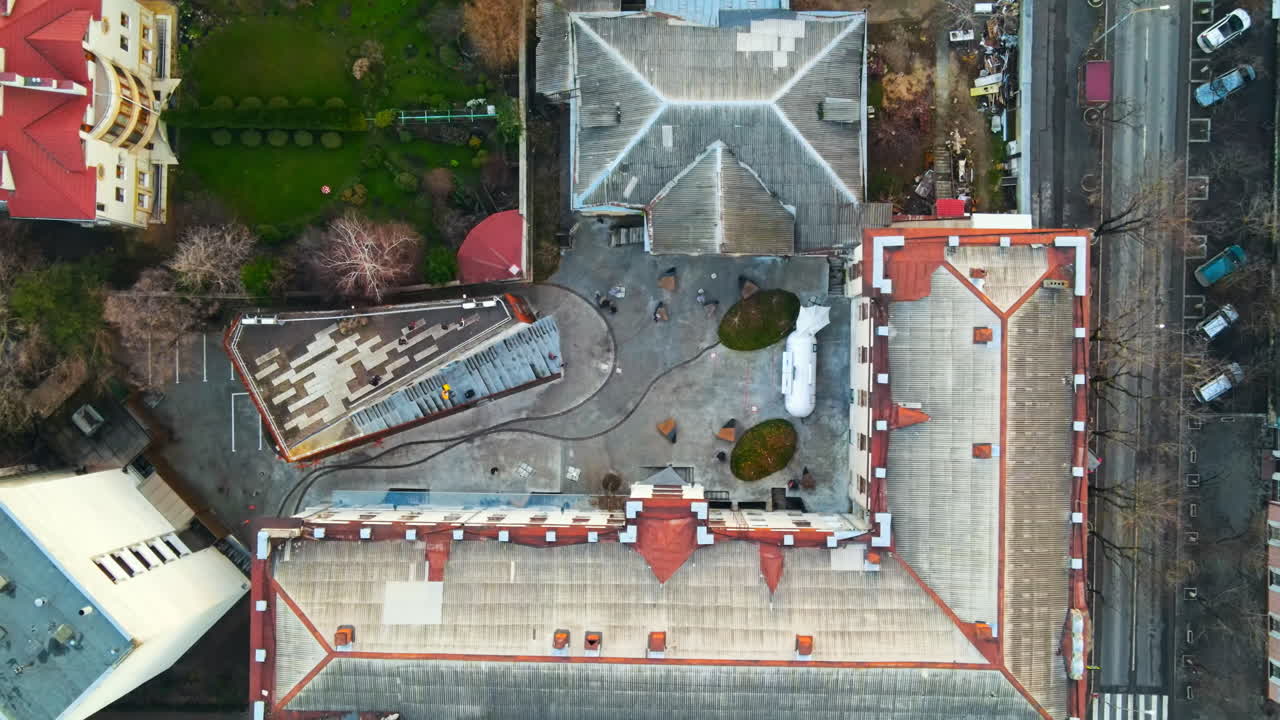 Aerial drone view of ARTCOR Creative Center with people inside, bare trees. Moldova
