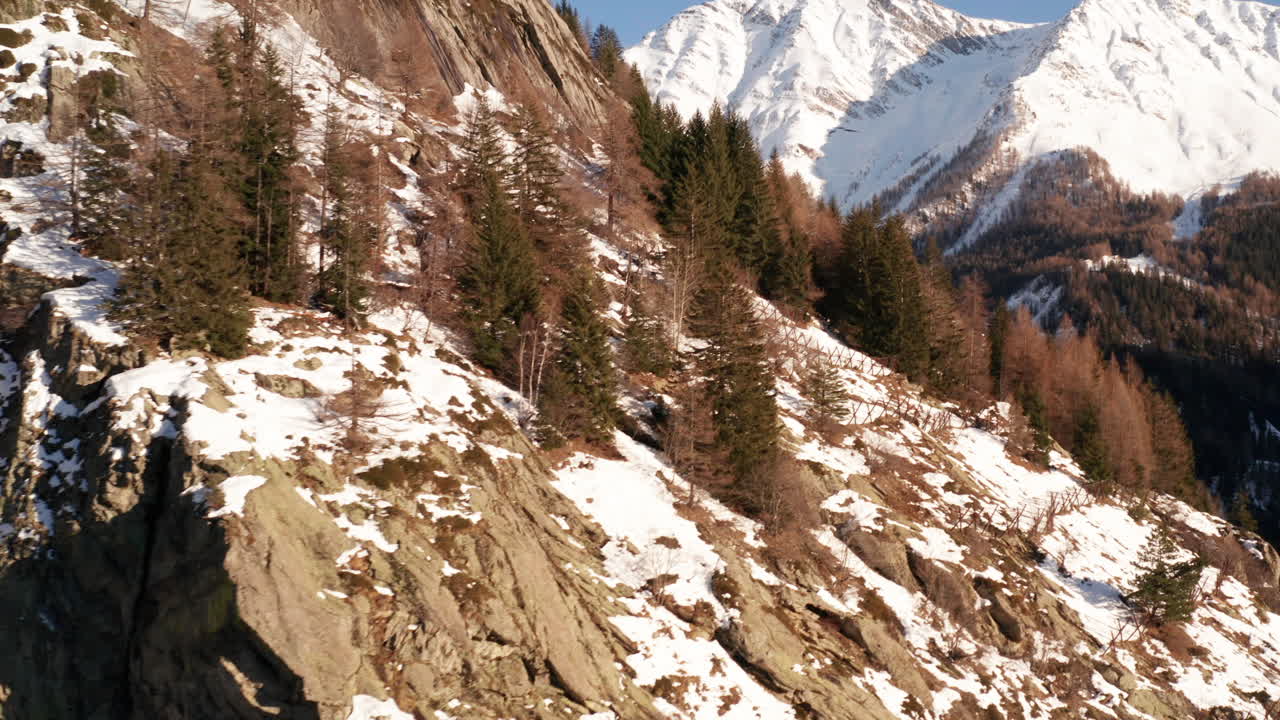 Aerial over cliffs and rocky mountain slope in winter