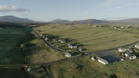 Aerial-landscape-shot-of-the-village-of-Durness-and-the-hills-and-mountains-standing-in-the-background