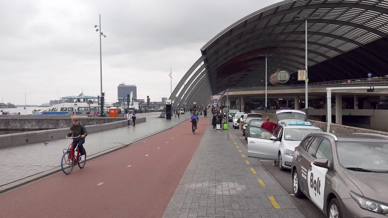 View on the busy Amsterdam-Centraal railway station area - The Netherlands