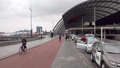 view on the busy amsterdam-centraal railway station area - the netherlands