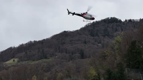 a close-up view captures a rescue helicopter in action amidst the swiss alps in wessen