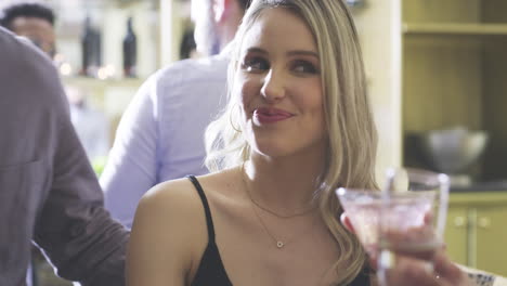 friends enjoying cocktails at a bar