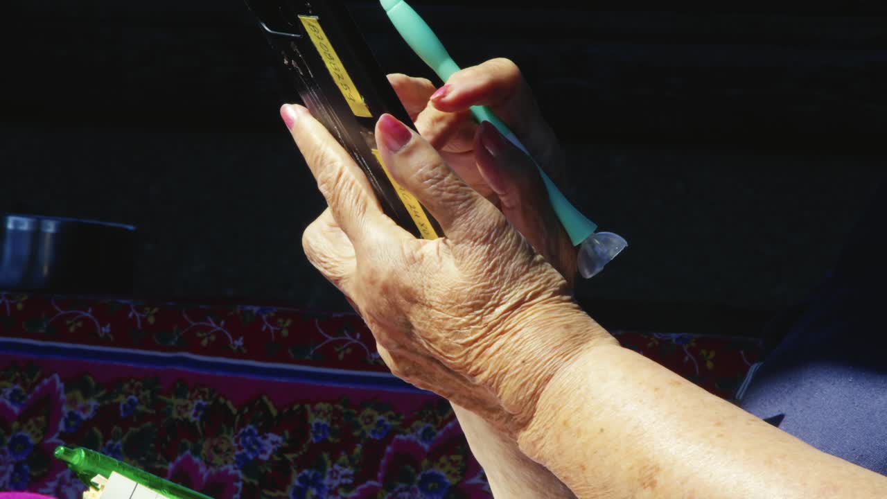 Independent Senior Lady scrolls screen using mobile phone Technology