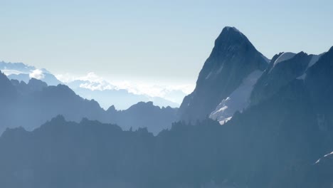 a view of the mountains of the alps, in chamonix, during a sunrise with clouds